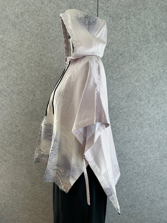 White dress with silver accents on a gray background