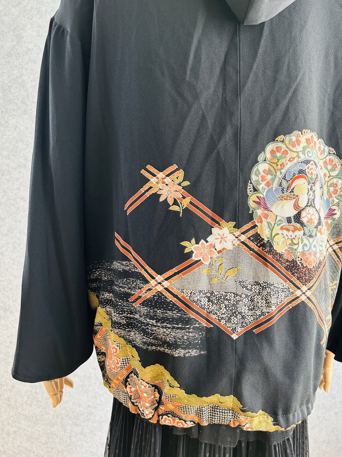 Black kimono hoodie lower back with lattice and gold pine design, side view