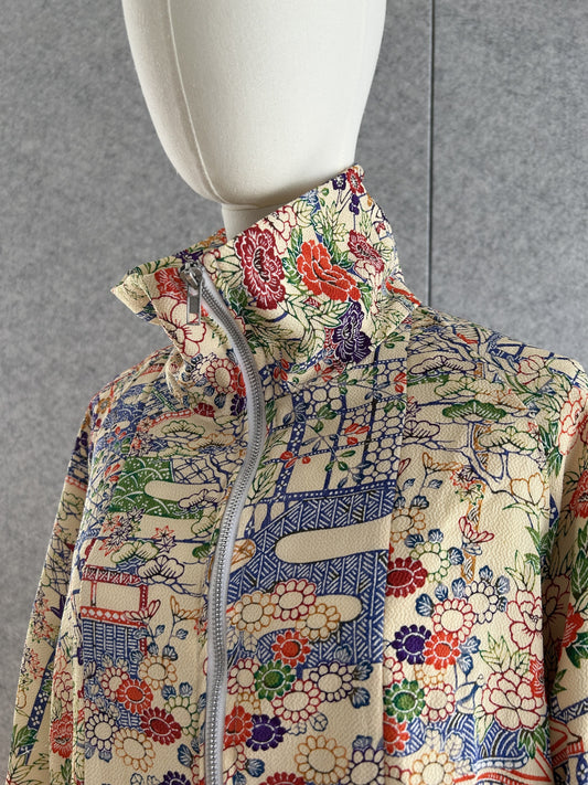 Cream high collar kimono jacket with colourful flowers, detail of collar and shoulder