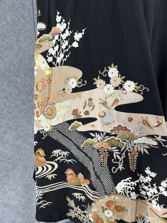 Detail of mandarin ducks, plum blossoms and pine on black kimono silk