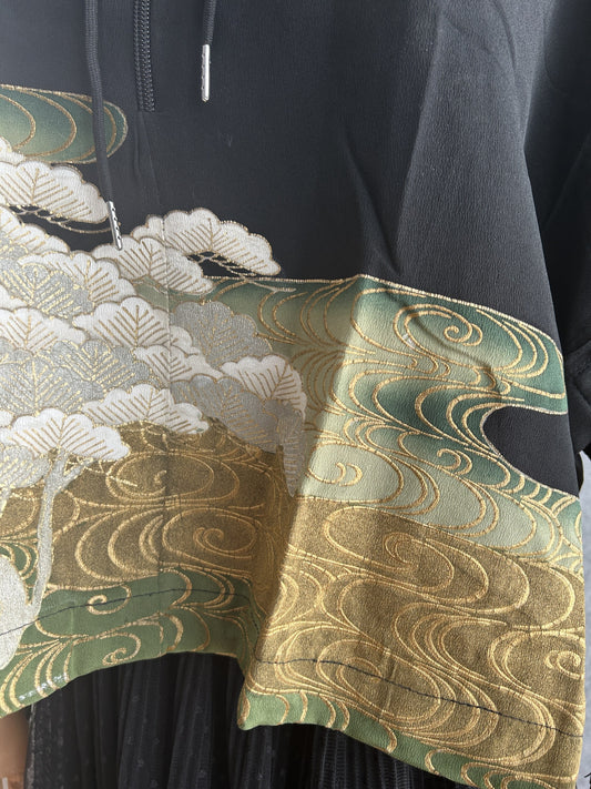 Close-up of white pine and green and gold swirling water near the hem