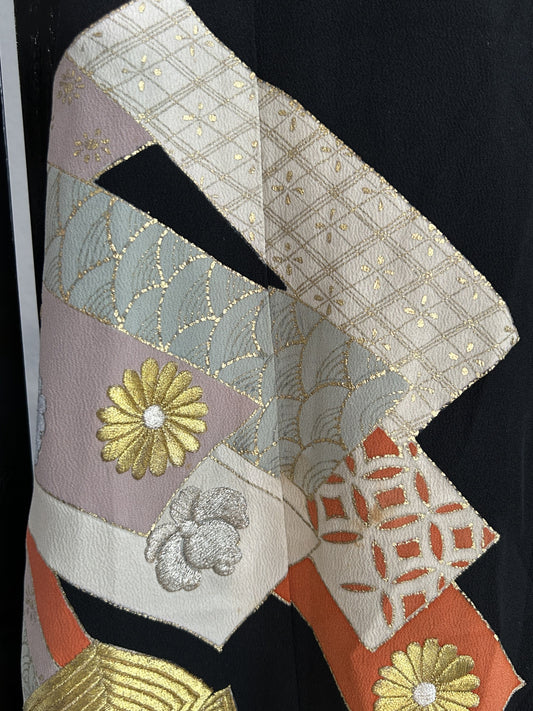 Cream, grey and orange ribbon bands with gold flower on black skirt