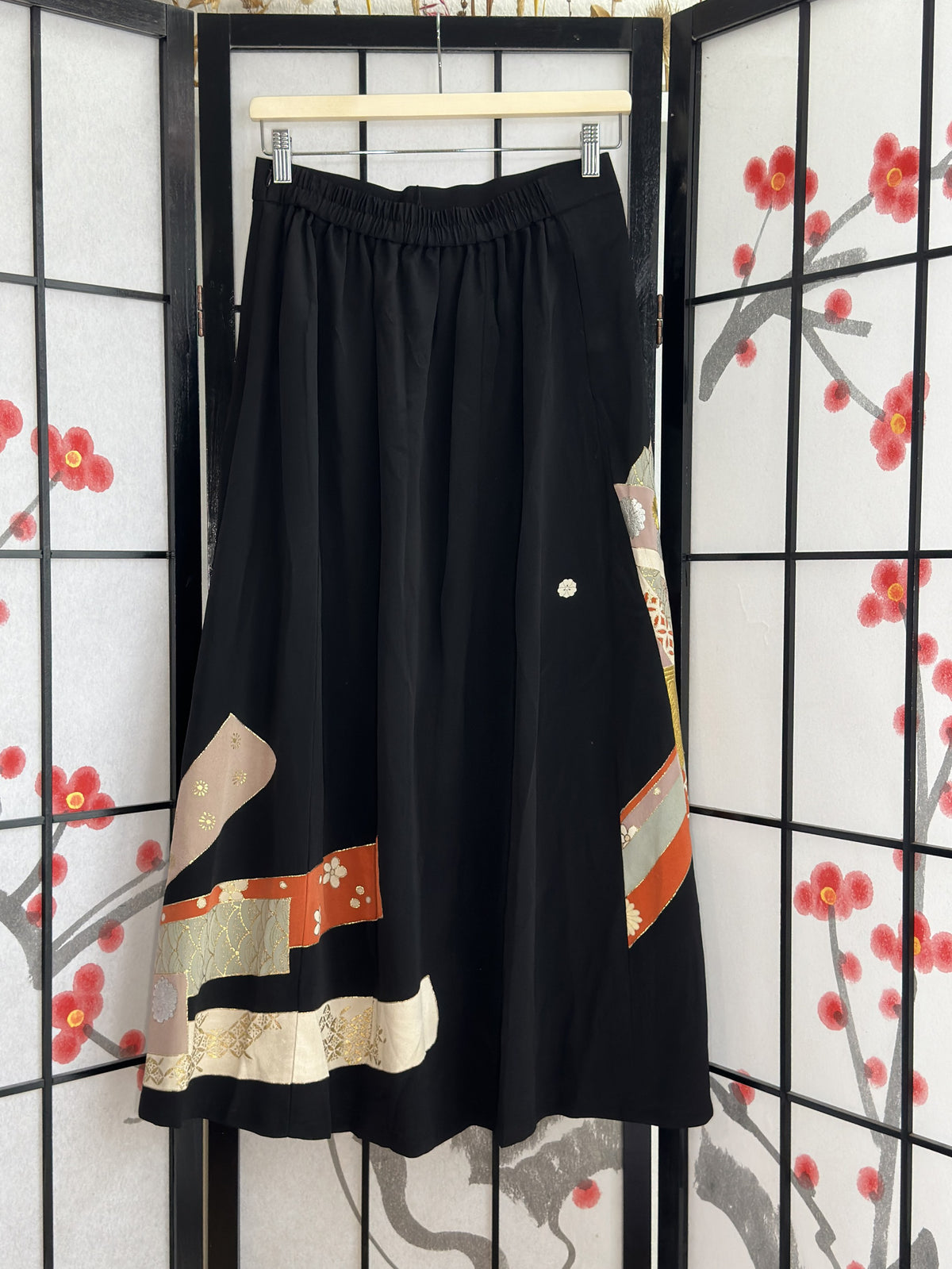 Black kimono skirt with elastic waistband and ribbon bands, back view