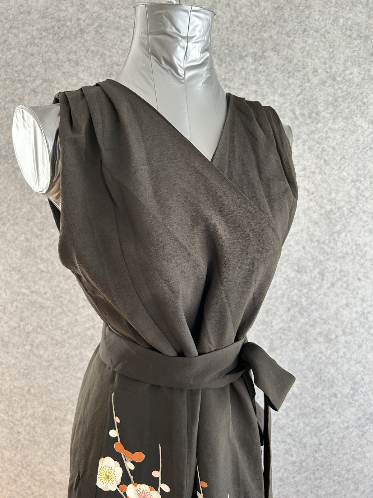 Black sleeveless kimono wrap dress with tie belt, upper body front view