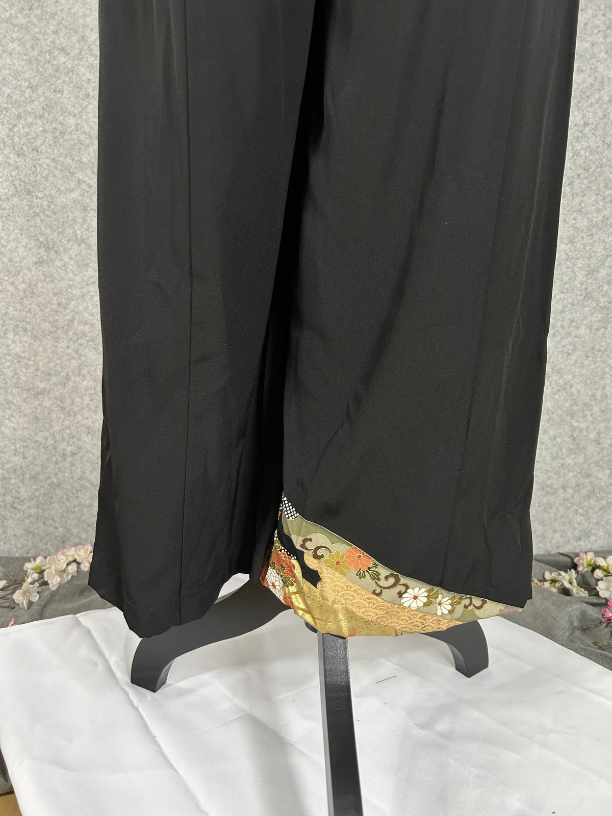 Black upcycled tomesode kimono wide leg pants with gold bands, cranes and chrysanthemums, back view