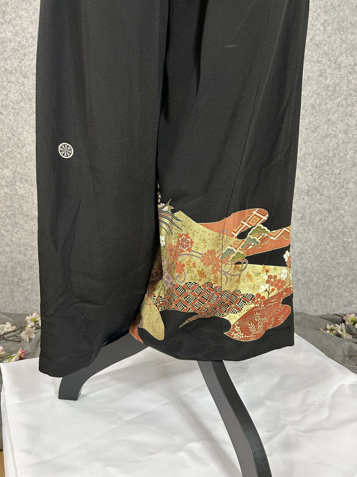 Black upcycled tomesode kimono wide leg pants with birds, gold clouds and pine, back view with family crest