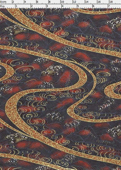 Decorative chiyogami paper with intricate patterns on a dark background with a ruler for scale