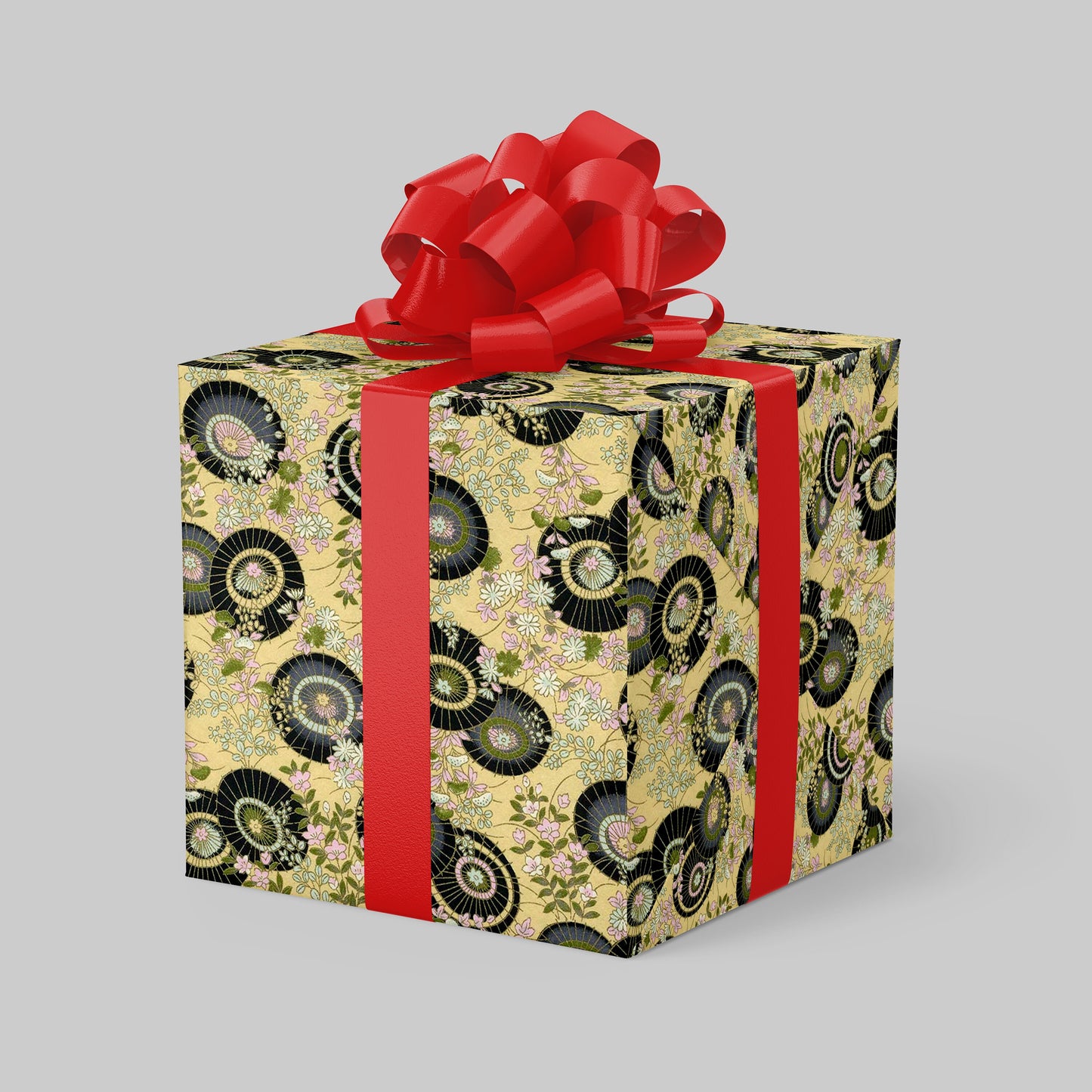 Gift box wrapped with chiyogami paper with decorative pattern and red ribbon on a gray background
