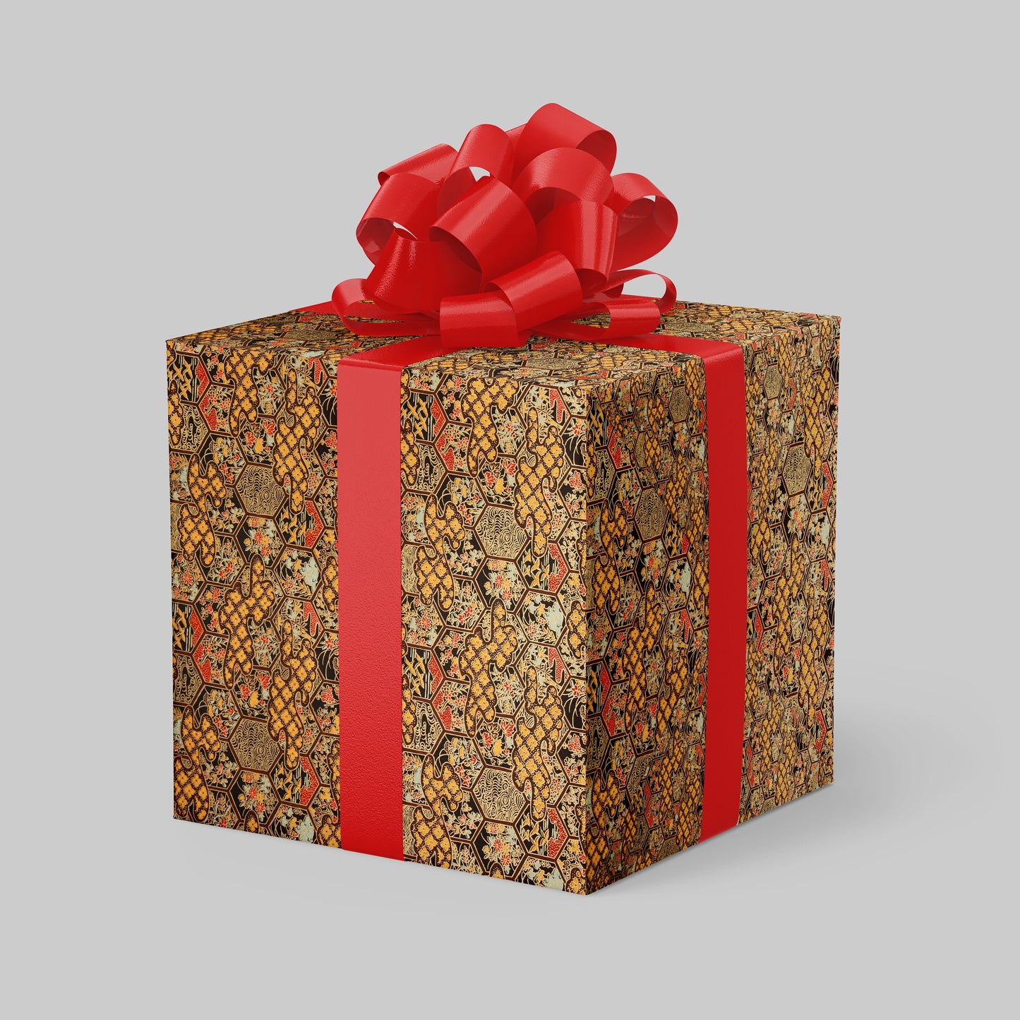 Gift box wrapped with chiyogami paper with patterned wrap and red ribbon on a gray background
