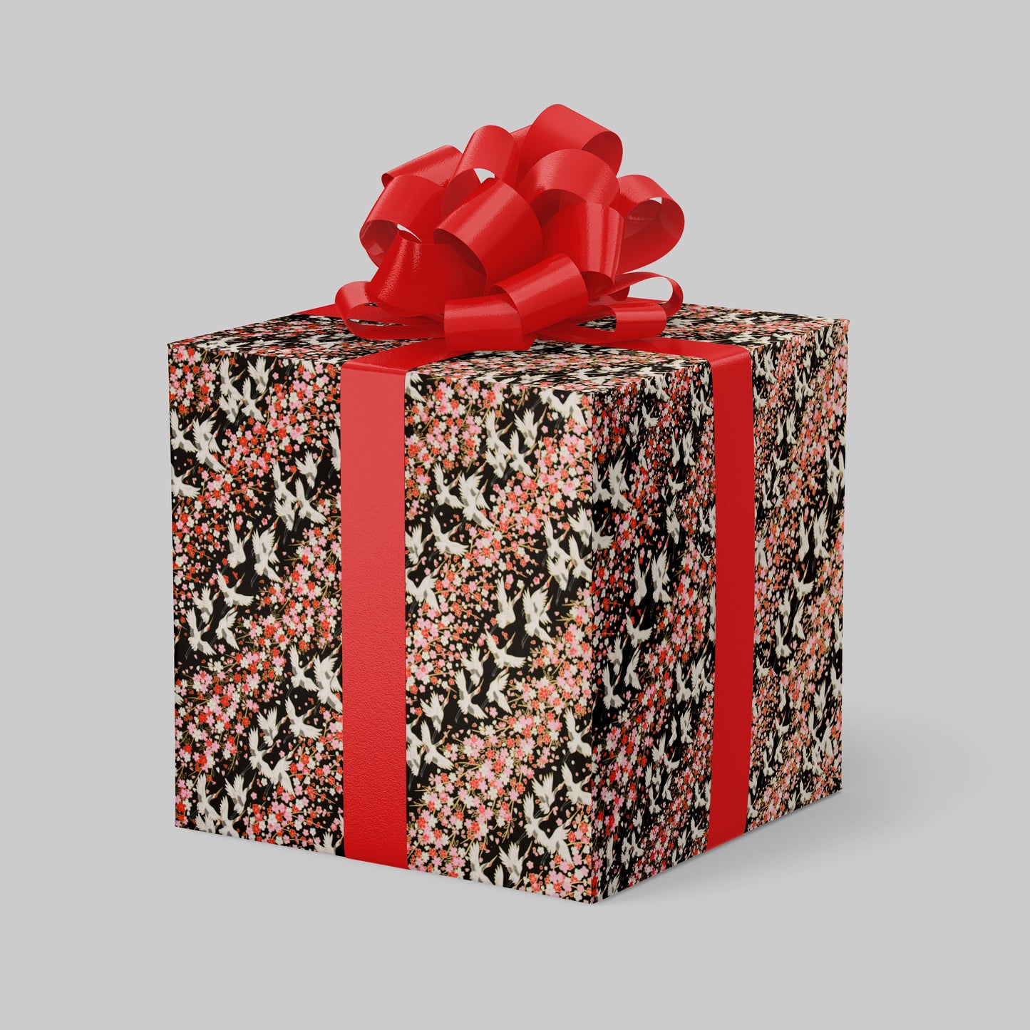 Gift box with floral pattern and red ribbon on a gray background