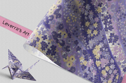 Floral-patterned paper with a folded paper crane and pink label on a light gray background