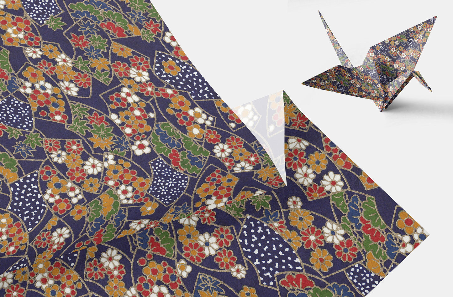 Floral patterned chiyogami paper with a folded paper crane on a white background