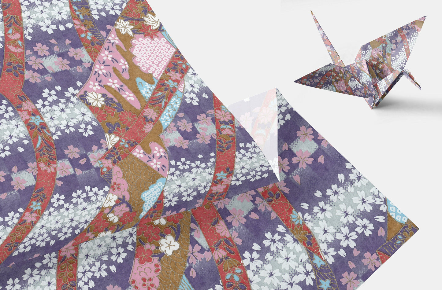Colorful chiyogami paper with floral patterns and an origami crane on a white background