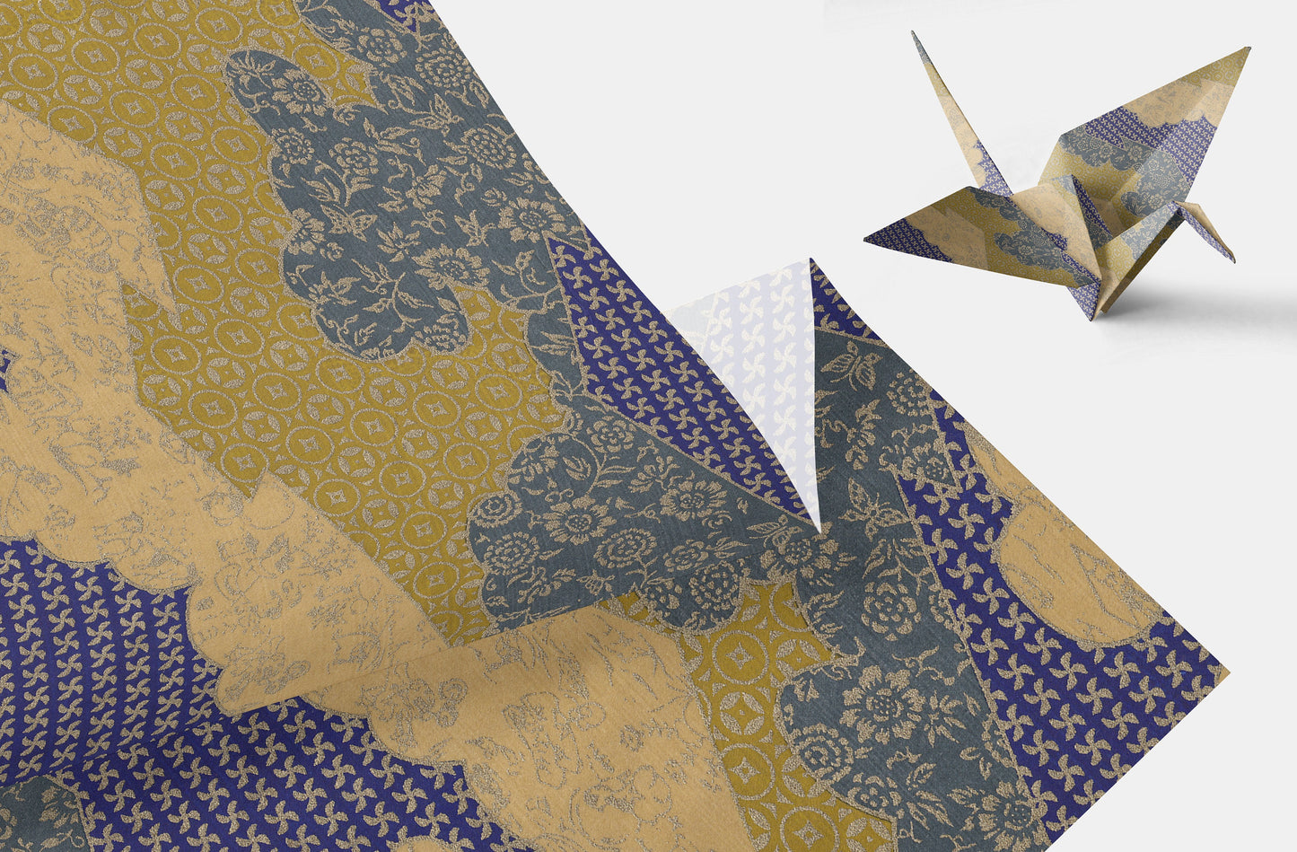 Patterned chiyogami paper with a folded paper crane on a white background