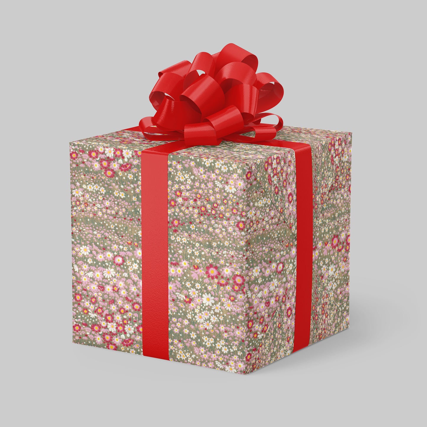 Gift box wrapped with chiyogami paper with floral pattern and red ribbon on a gray background