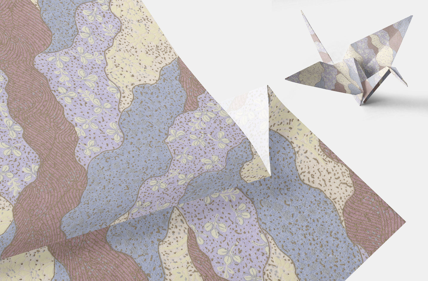 Decorative paper with geometric patterns and a folded paper crane on a light background