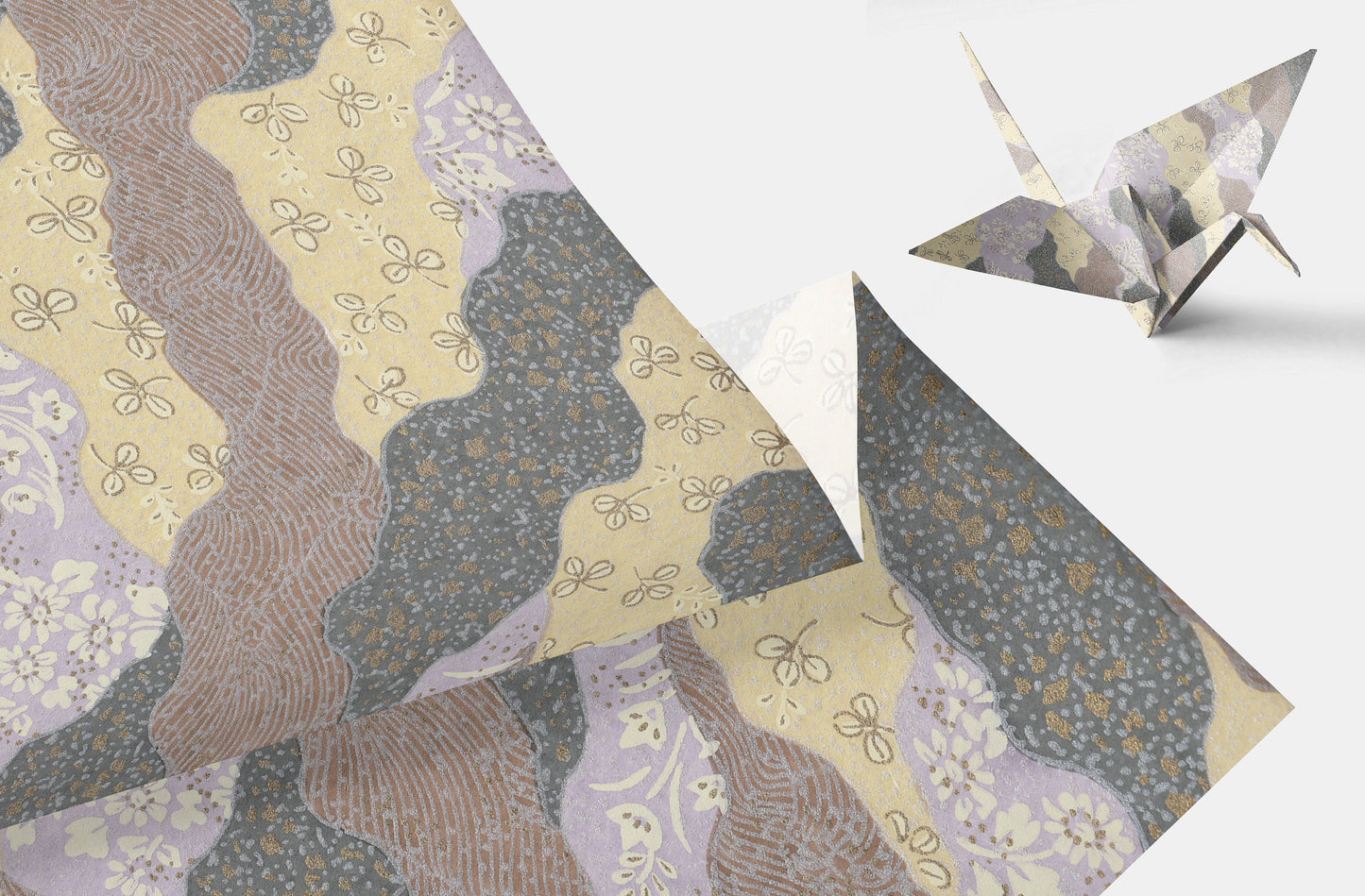 Decorative chiyogami paper with floral patterns and a folded paper crane on a light background