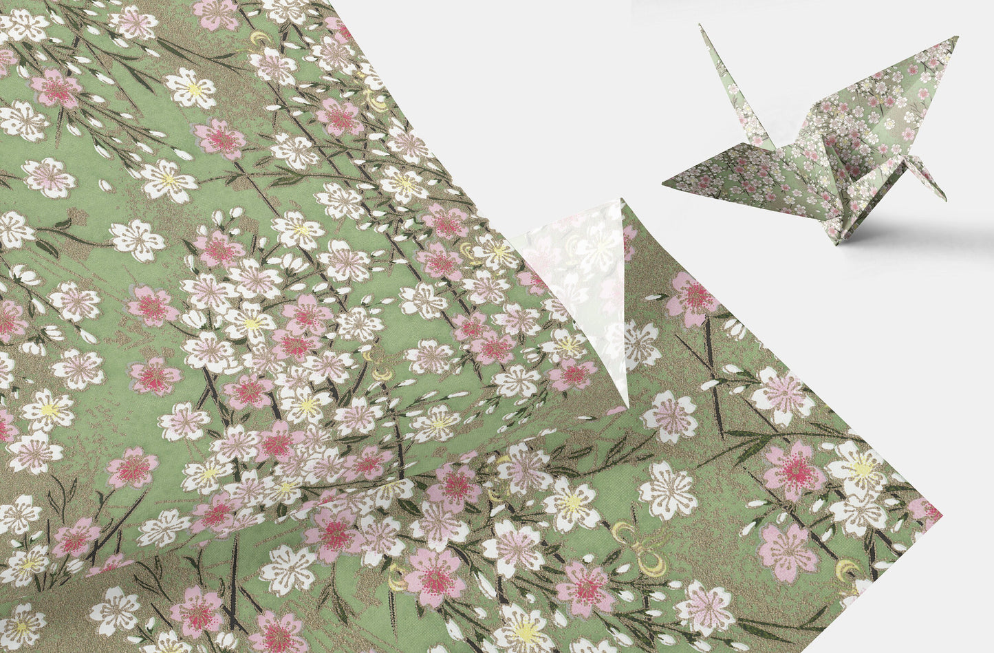 Floral-patterned paper with a folded paper crane on a white background