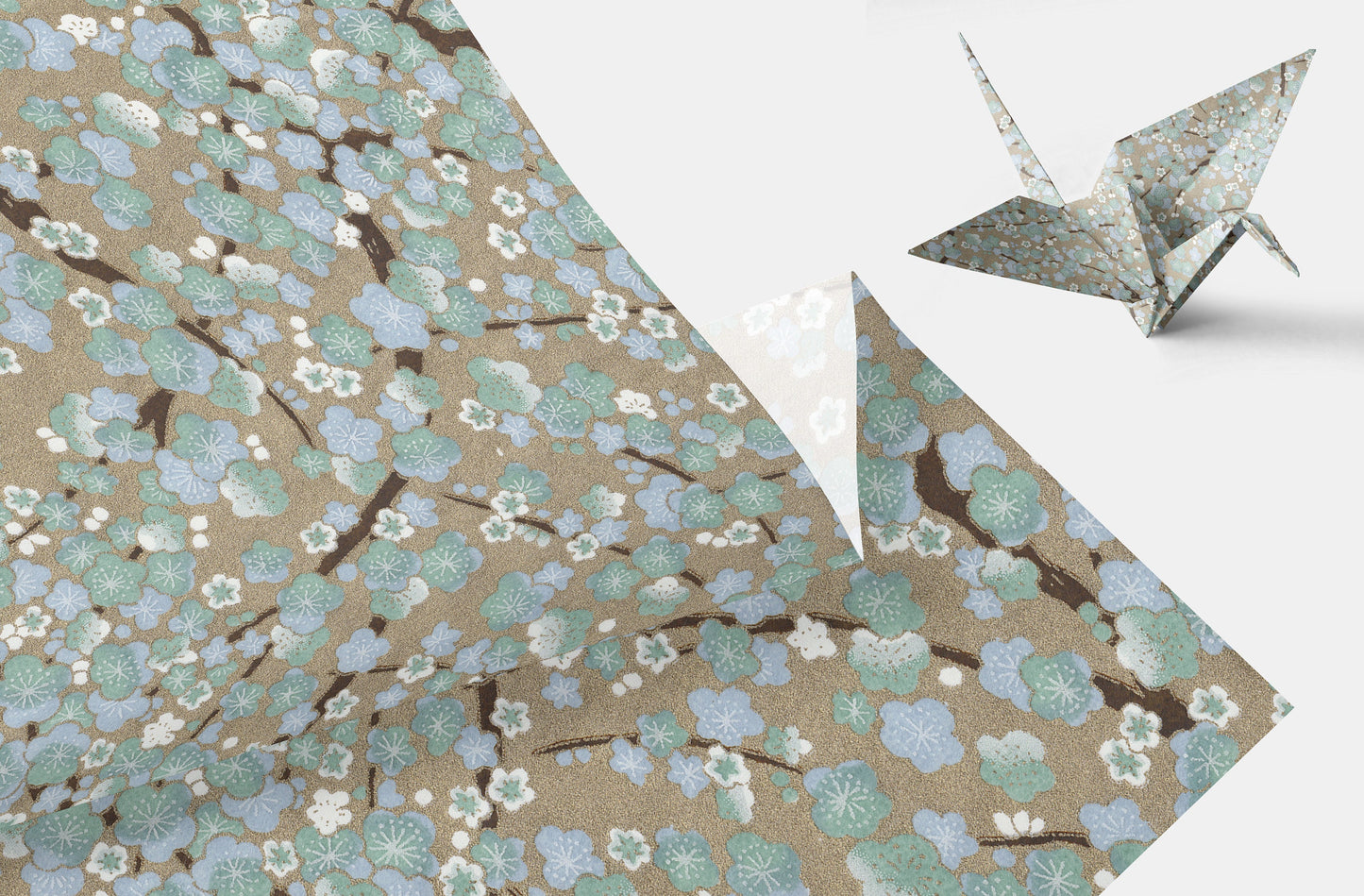 Origami crane on a floral-patterned chiyogami paper with cherry blossoms