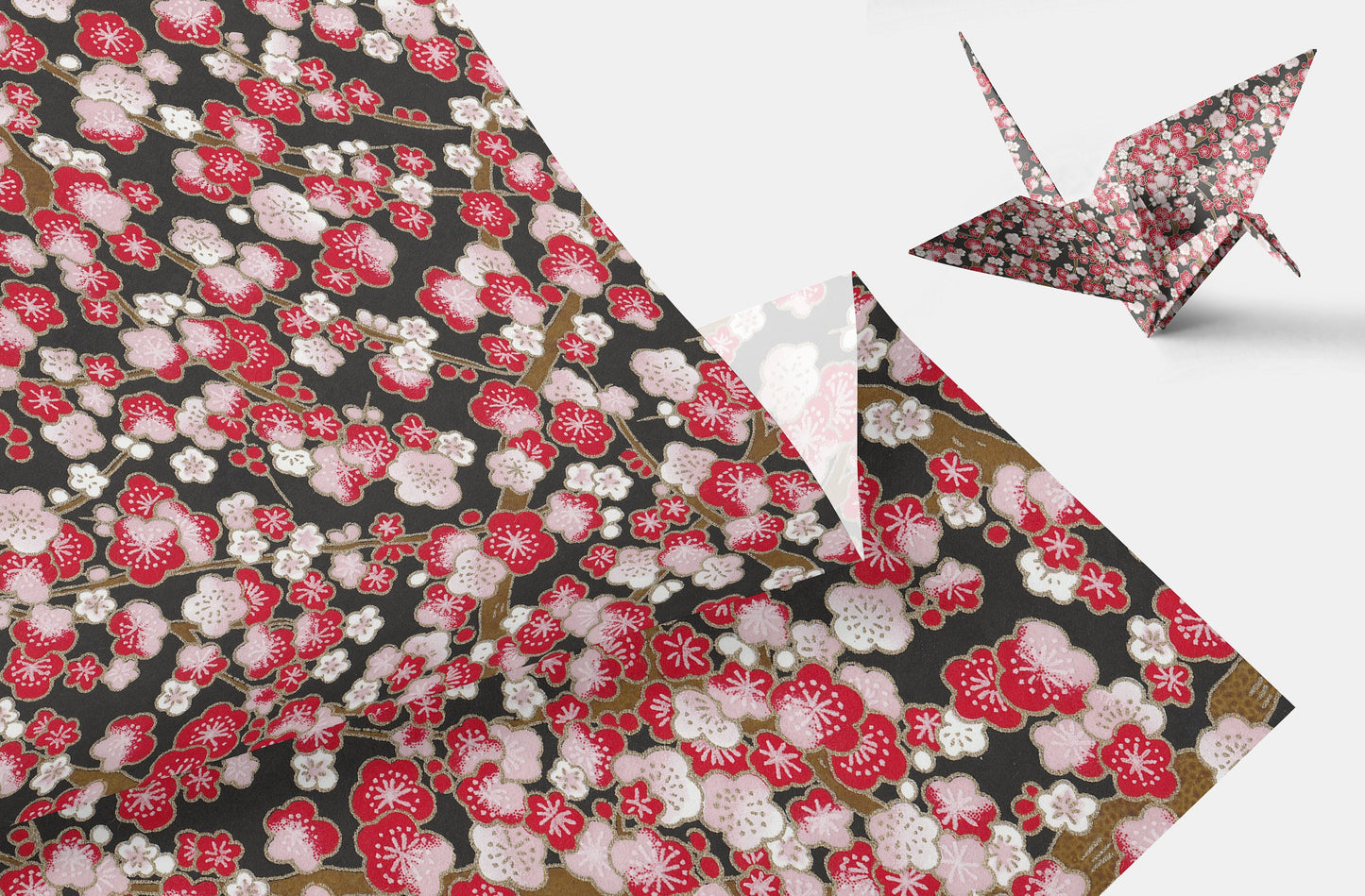 Floral patterned chiyogami paper with a folded paper crane on a white background