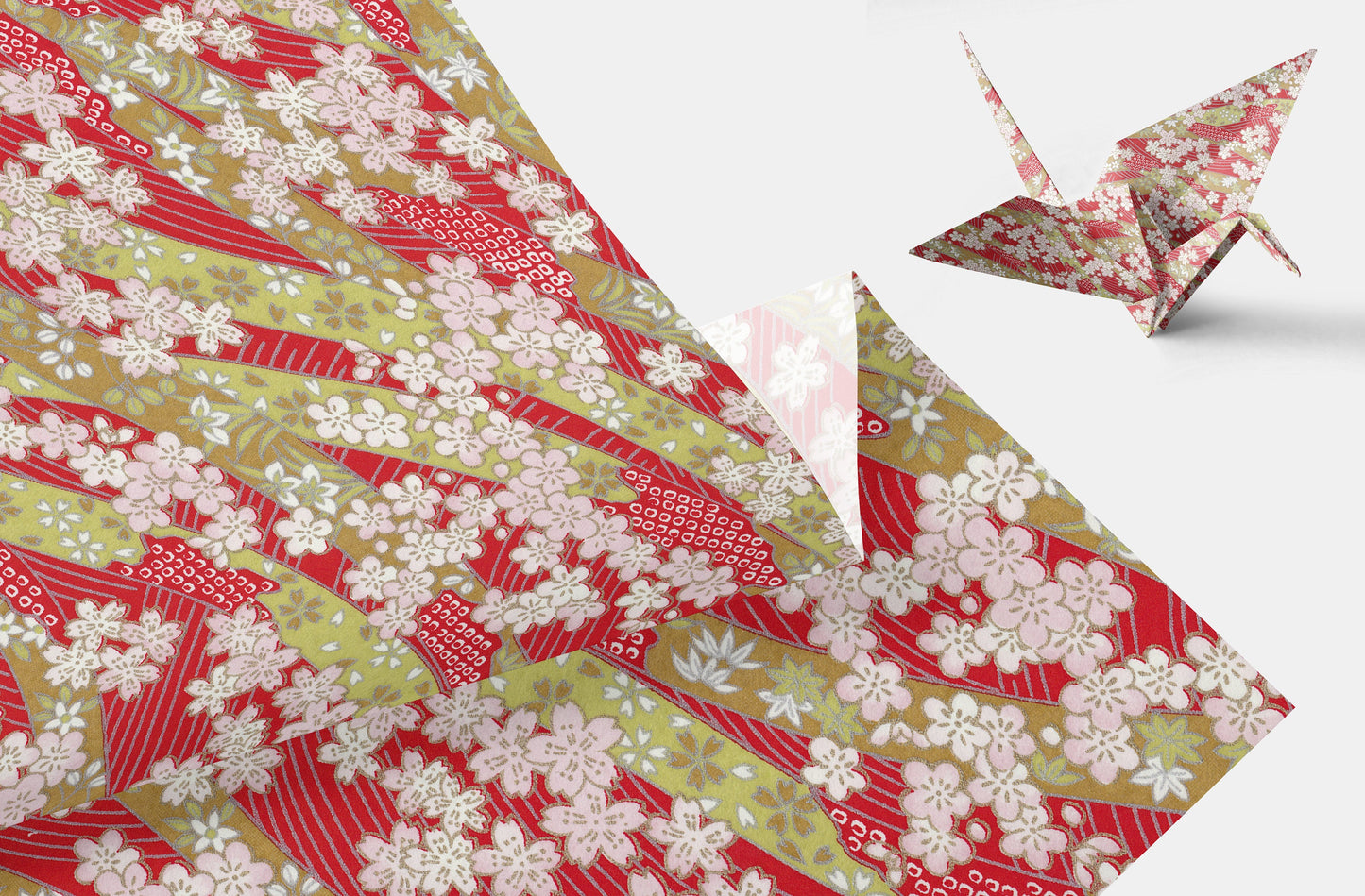 Floral-patterned chiyogami paper with a folded paper crane on a white background