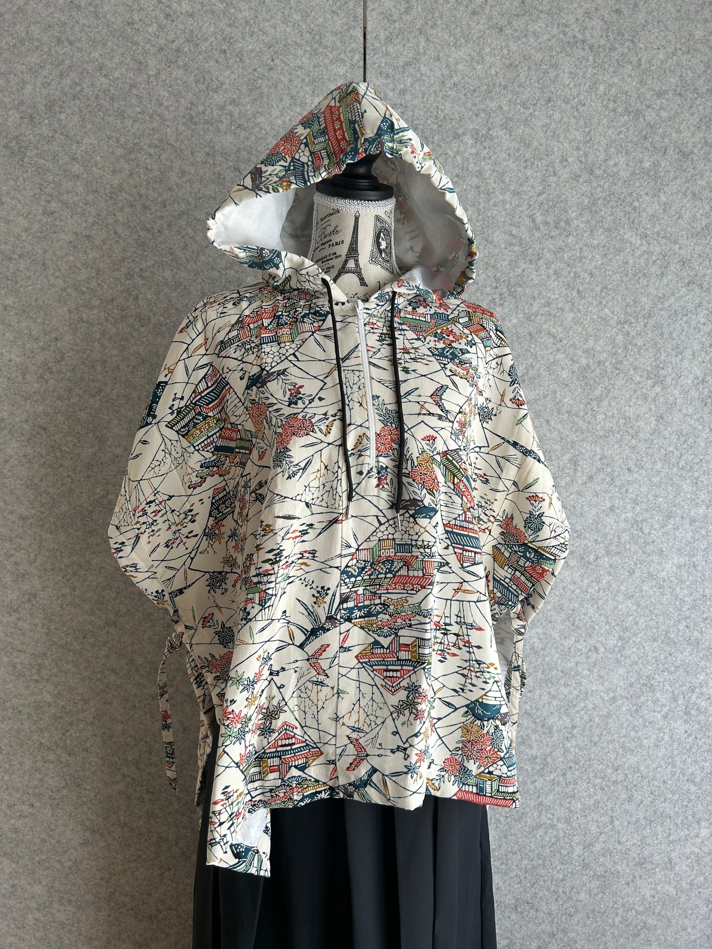 Patterned dress on a mannequin against a gray background