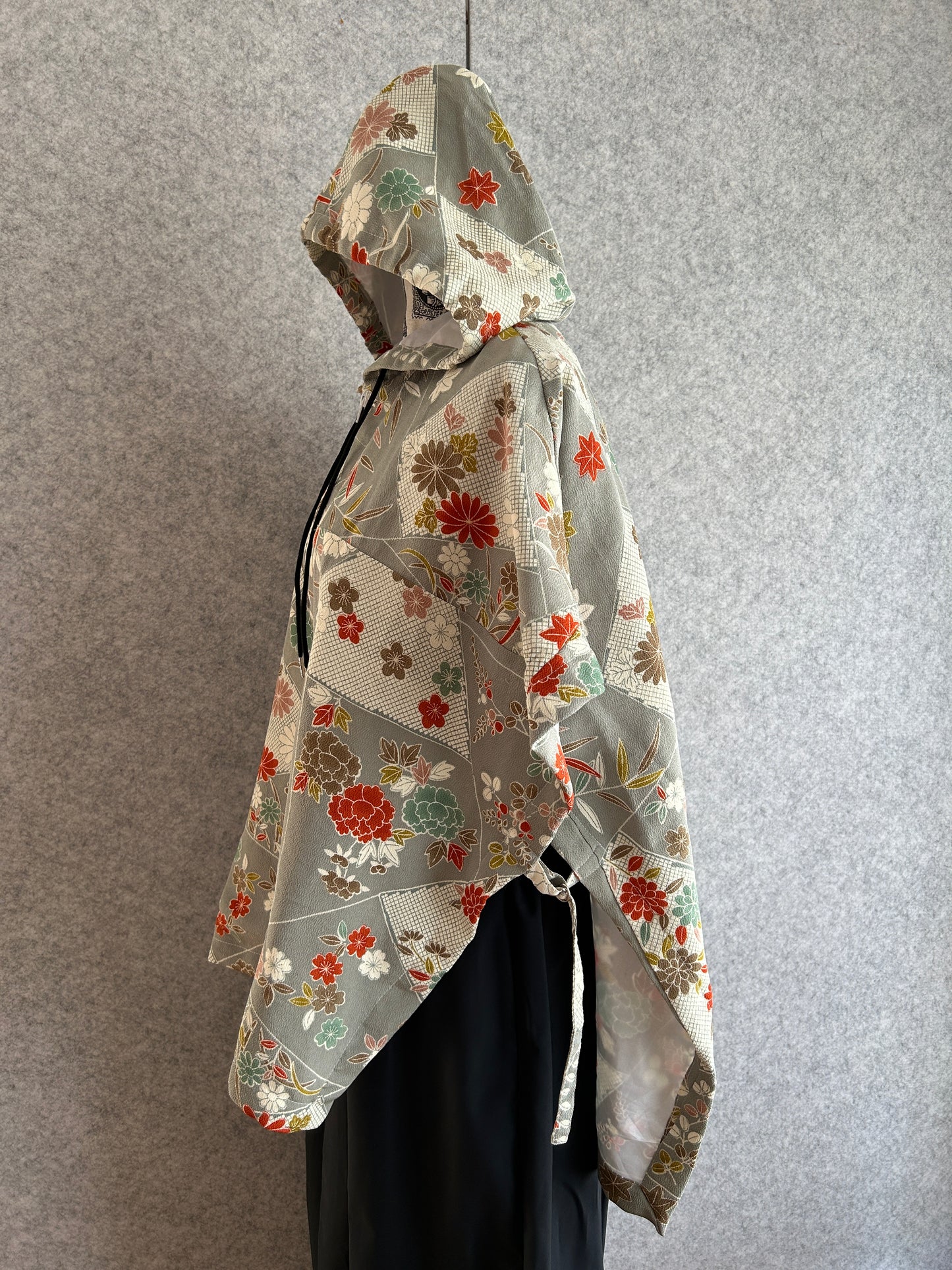 Floral-patterned motorcycle jacket on a gray surface