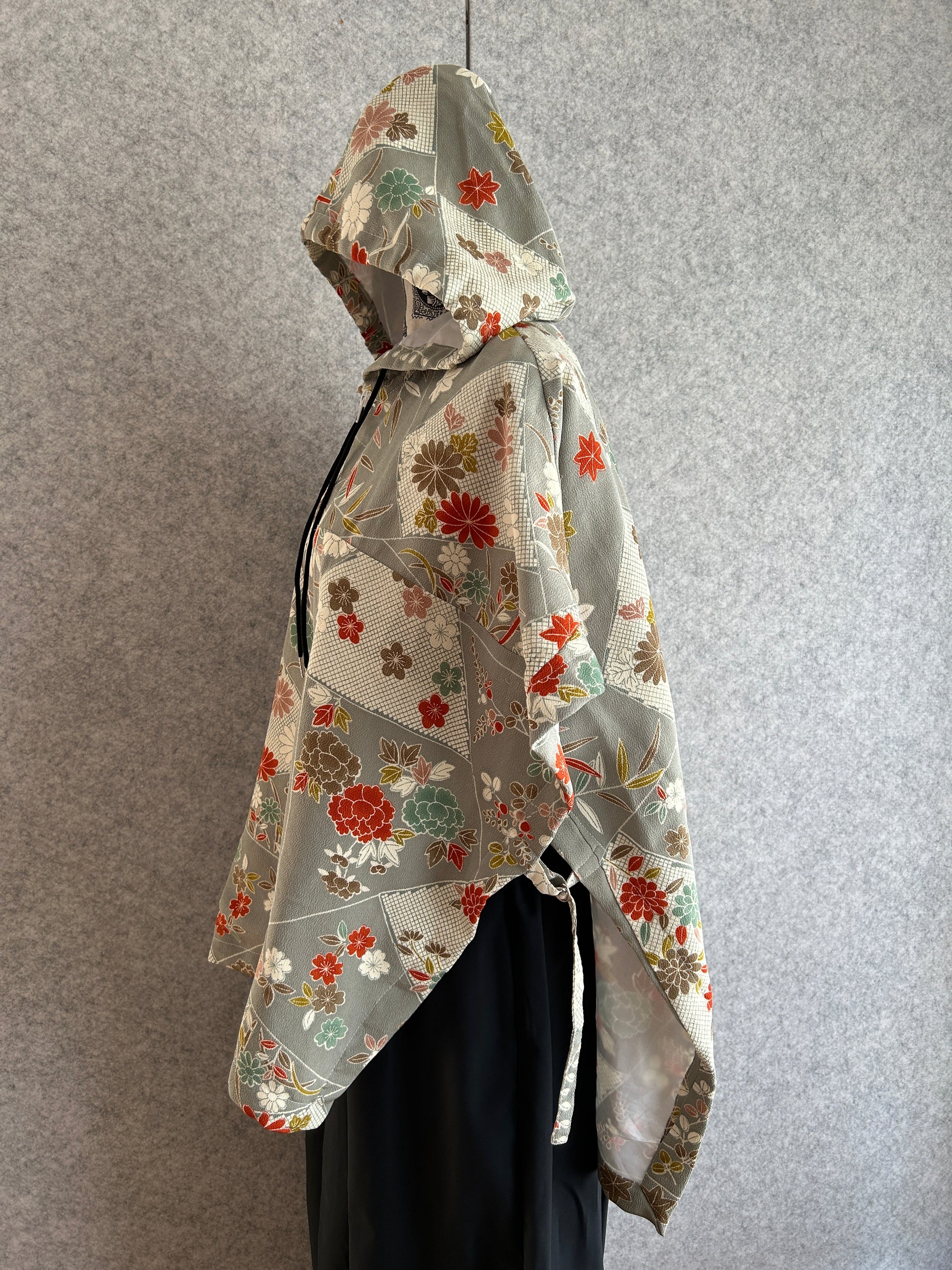 Floral-patterned motorcycle jacket on a gray surface