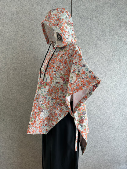 Floral-patterned dress on a mannequin against a gray background