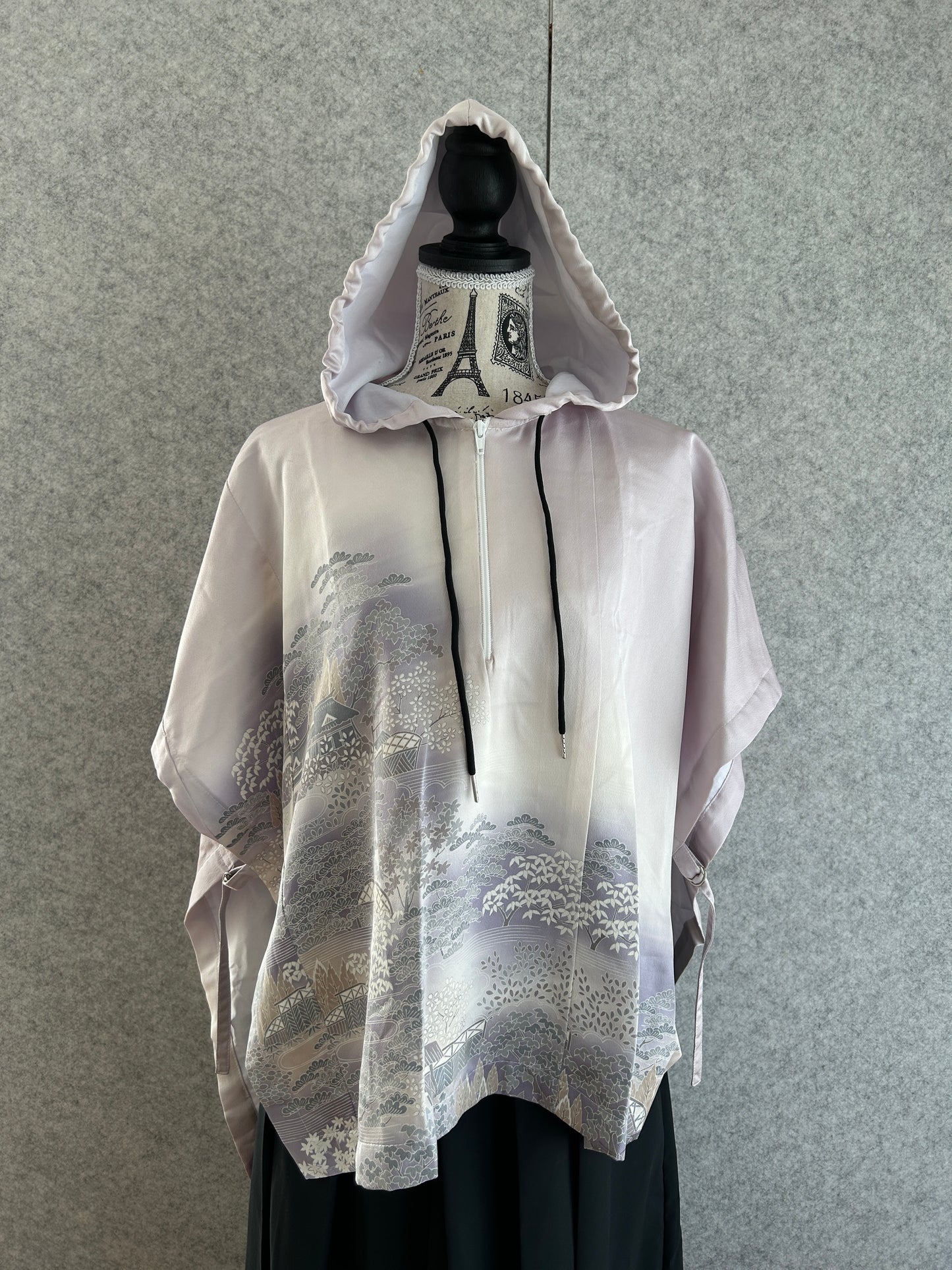 White raincoat with black accents on a gray background