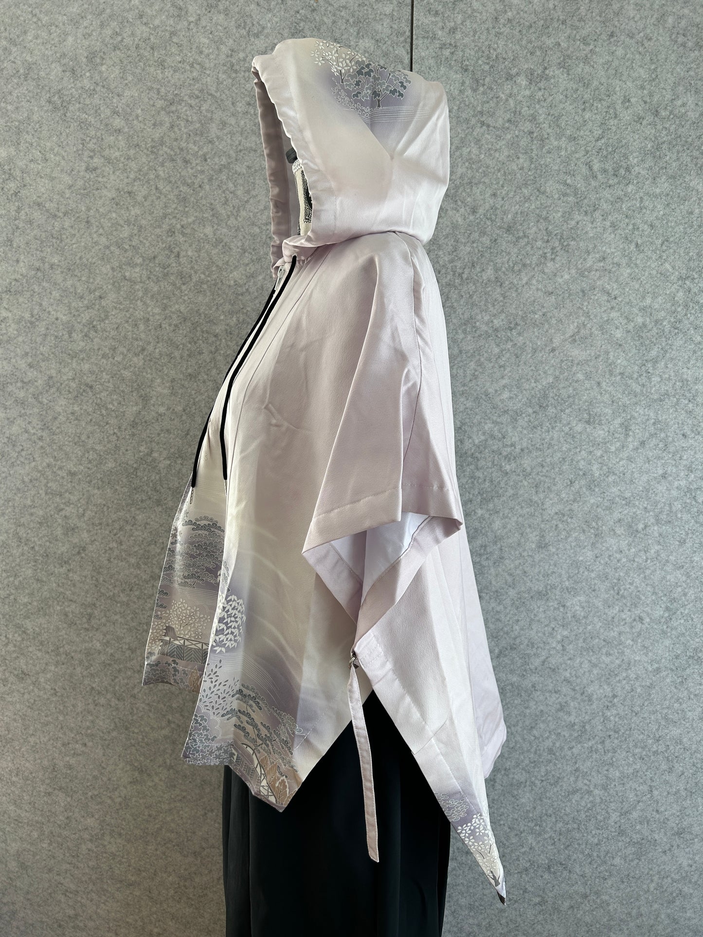 White dress with silver accents on a gray background