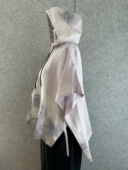 White dress with silver accents on a gray background