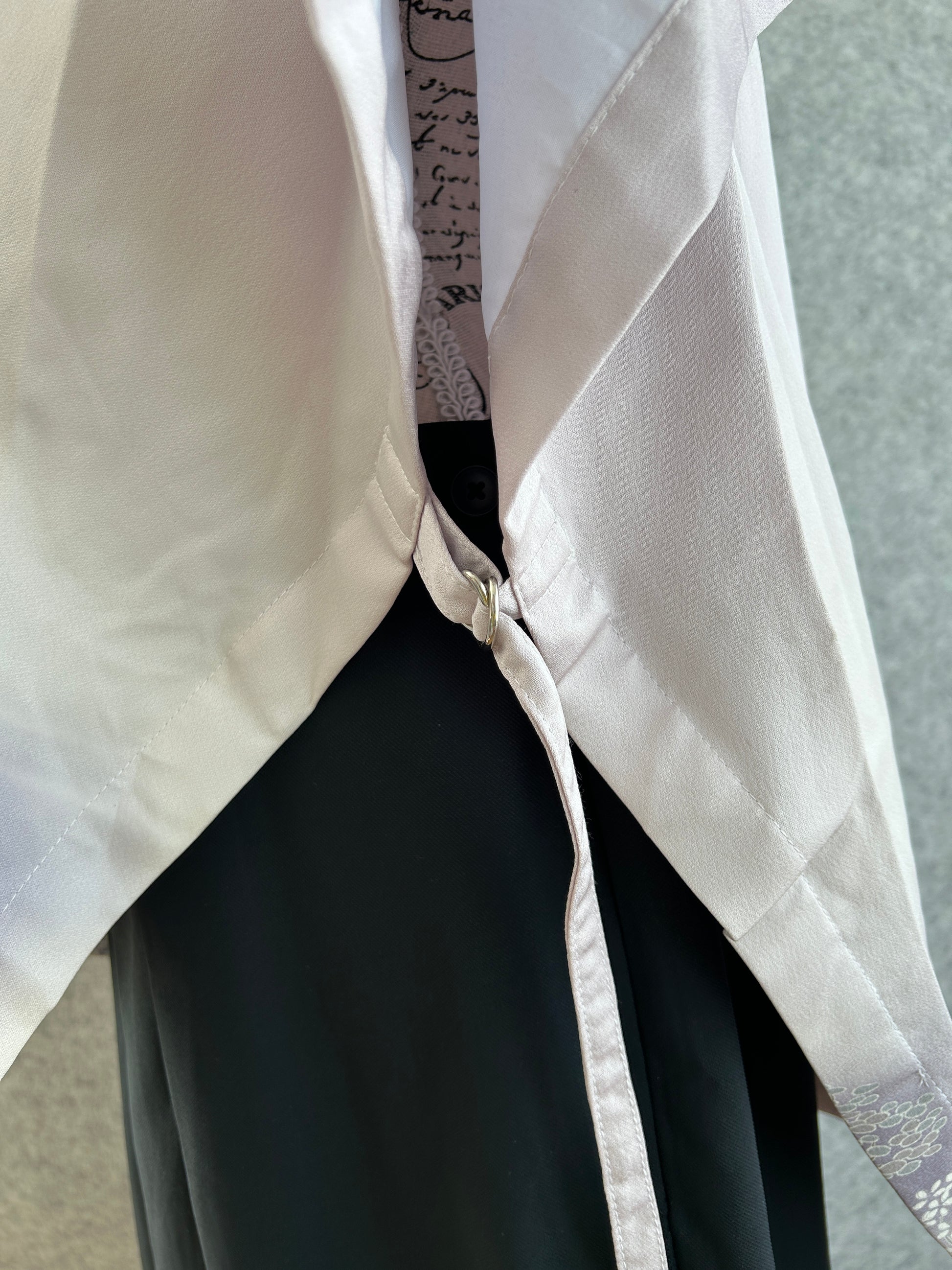 Close-up of a zipper on a garment with a neutral background