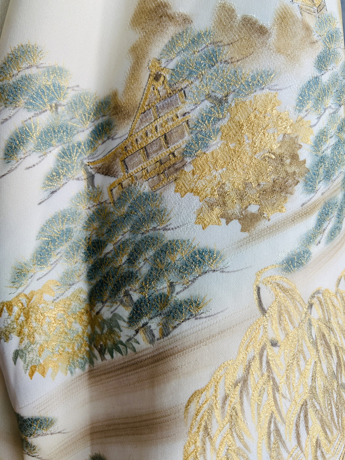 Close-up of gold pavilion and willow design on cream kimono fabric