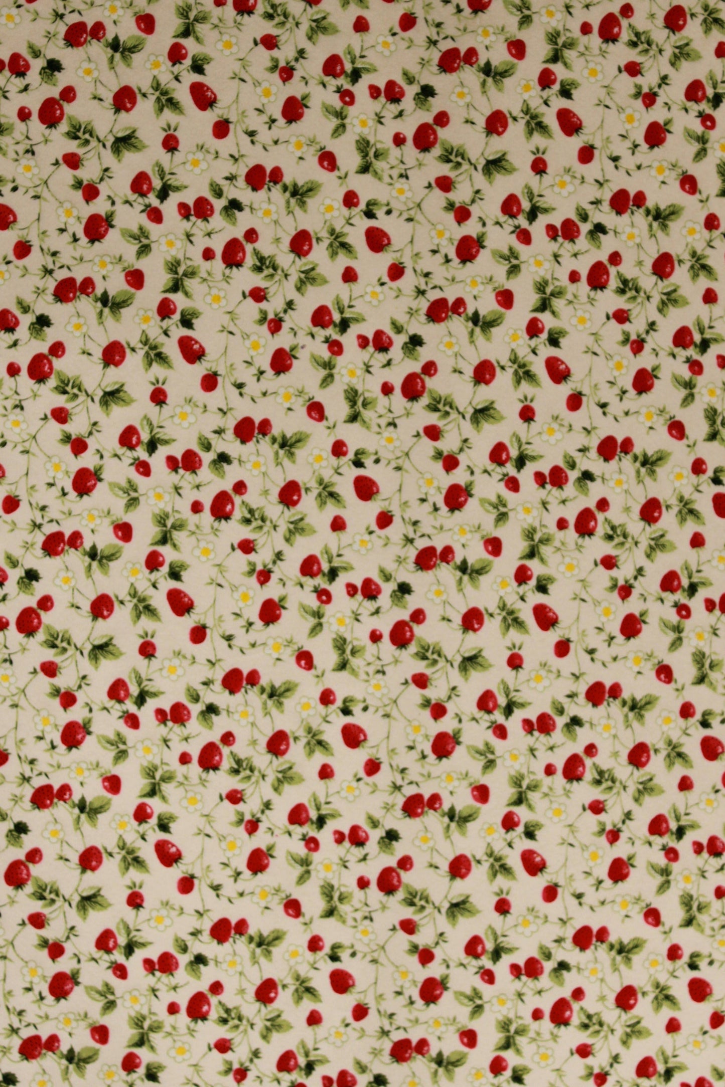 Pattern of red strawberries and green leaves on a beige background