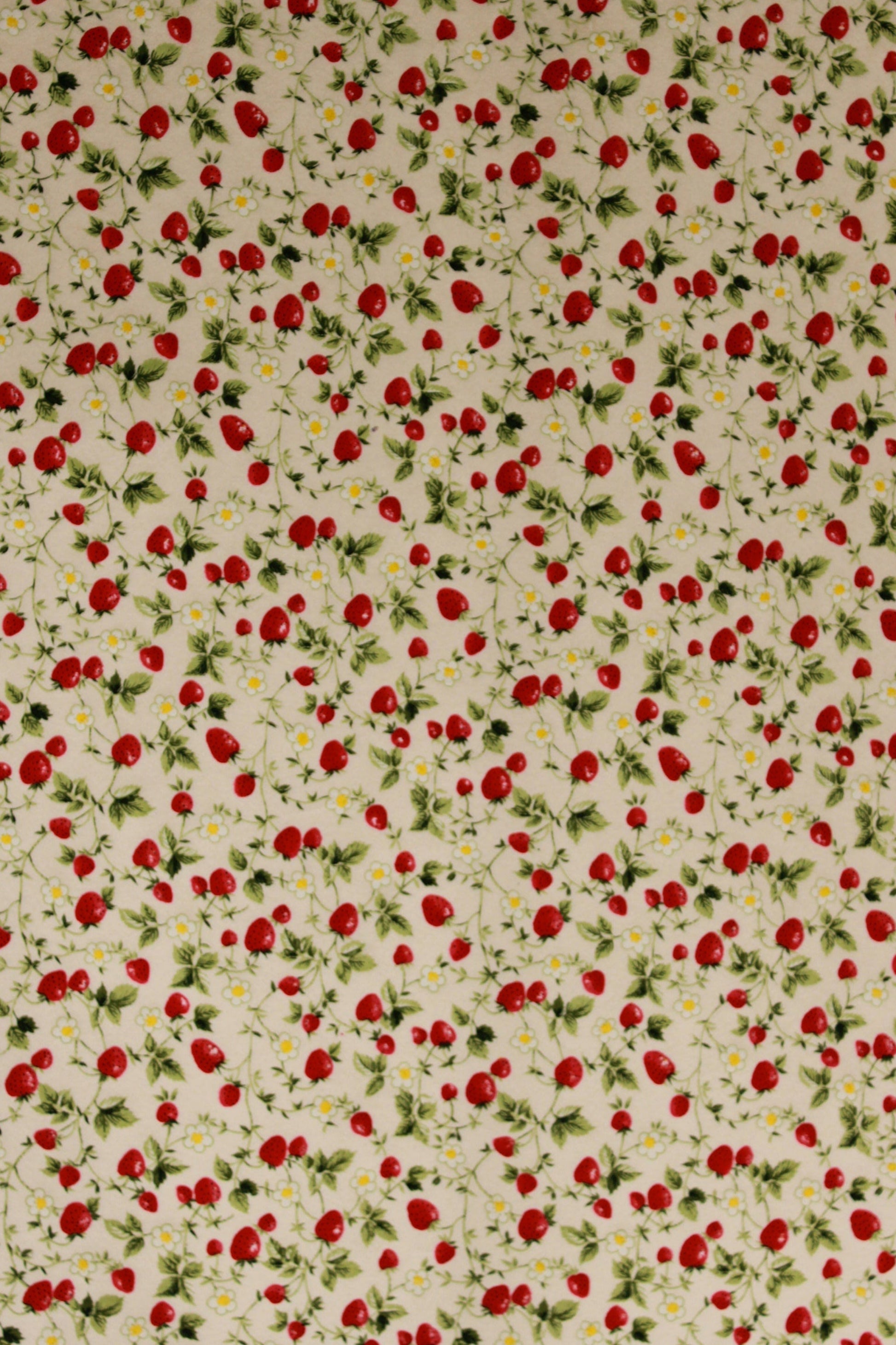 Pattern of red strawberries and green leaves on a beige background