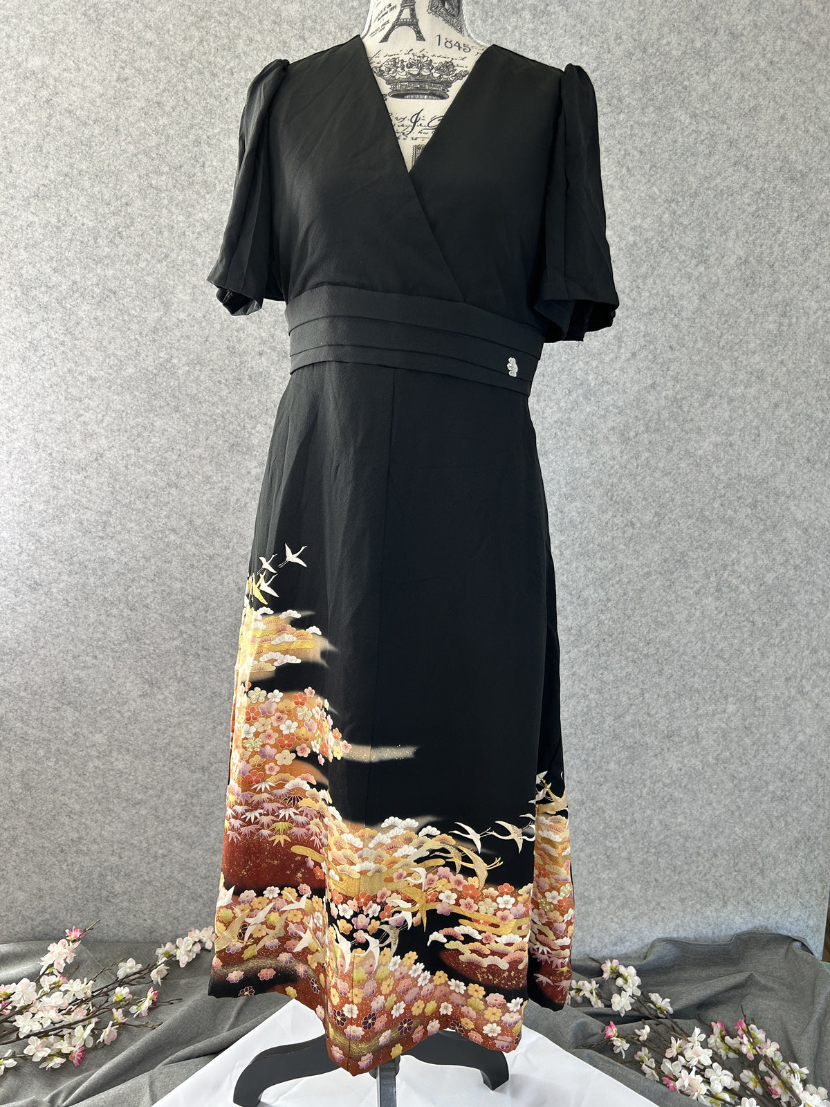 Black empire cut kimono dress with flutter sleeves and crane hem scene, front view