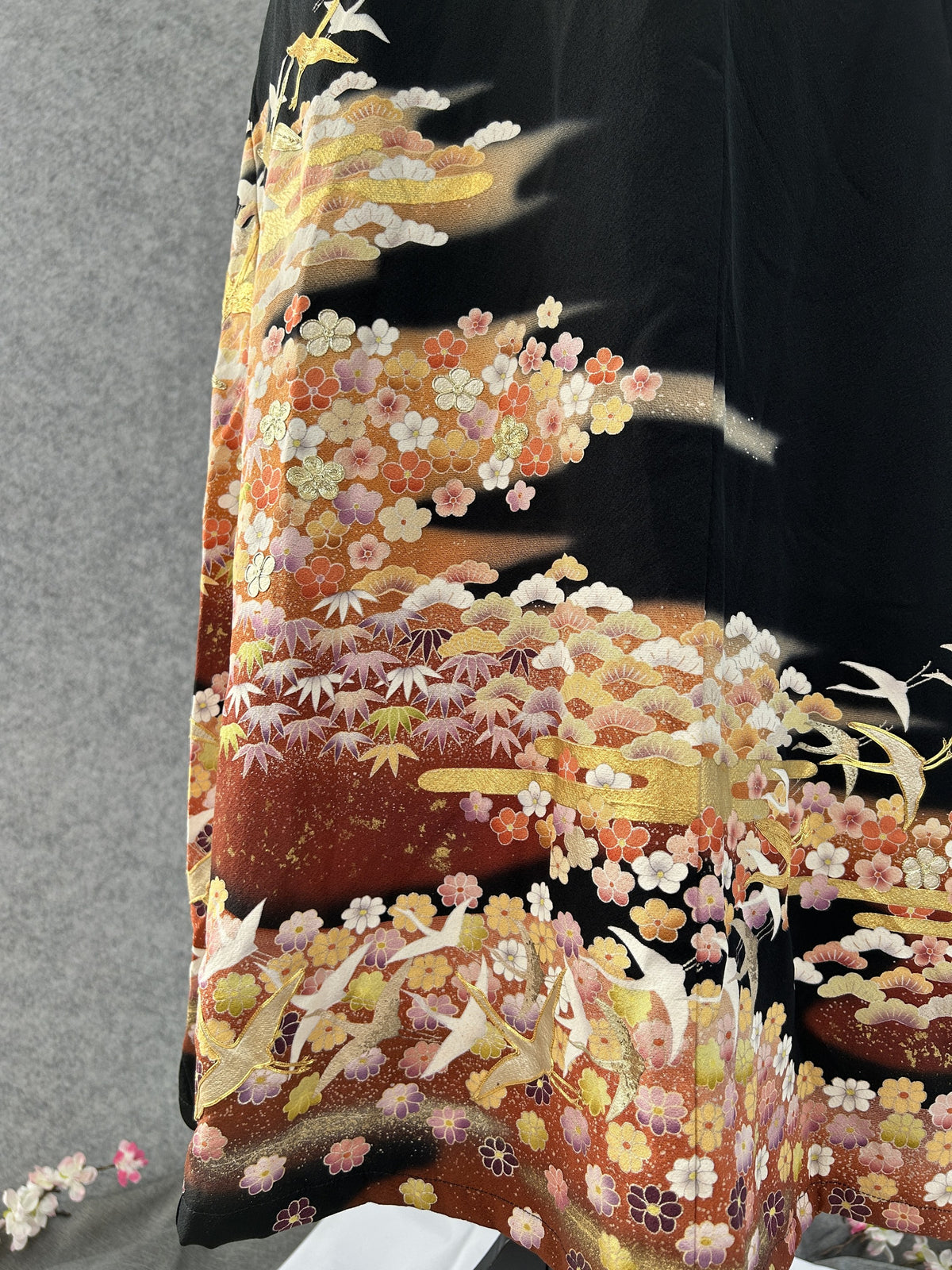 Flying white cranes and plum blossoms on the hem of black kimono dress