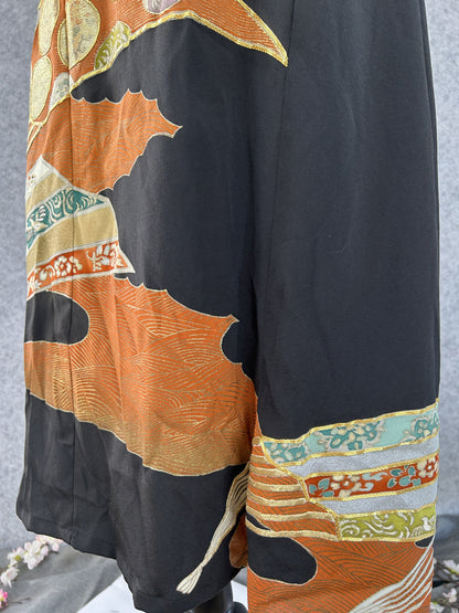 Orange cloud shapes and teal ribbon bands on black kimono dress skirt