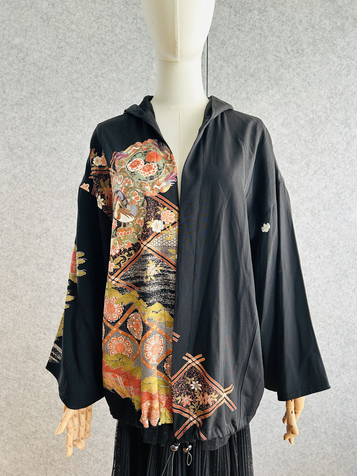 Black kimono hoodie with coral and gold floral medallion design, front view