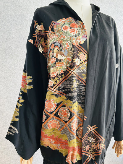Black kimono hoodie with patterned front panel, three-quarter side view