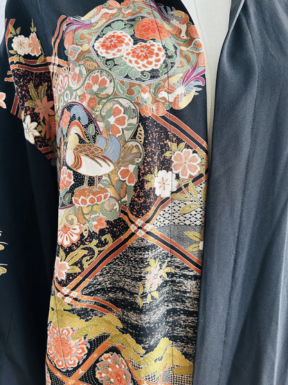 Black kimono hoodie, detail of floral medallion with ducks and lattice bands