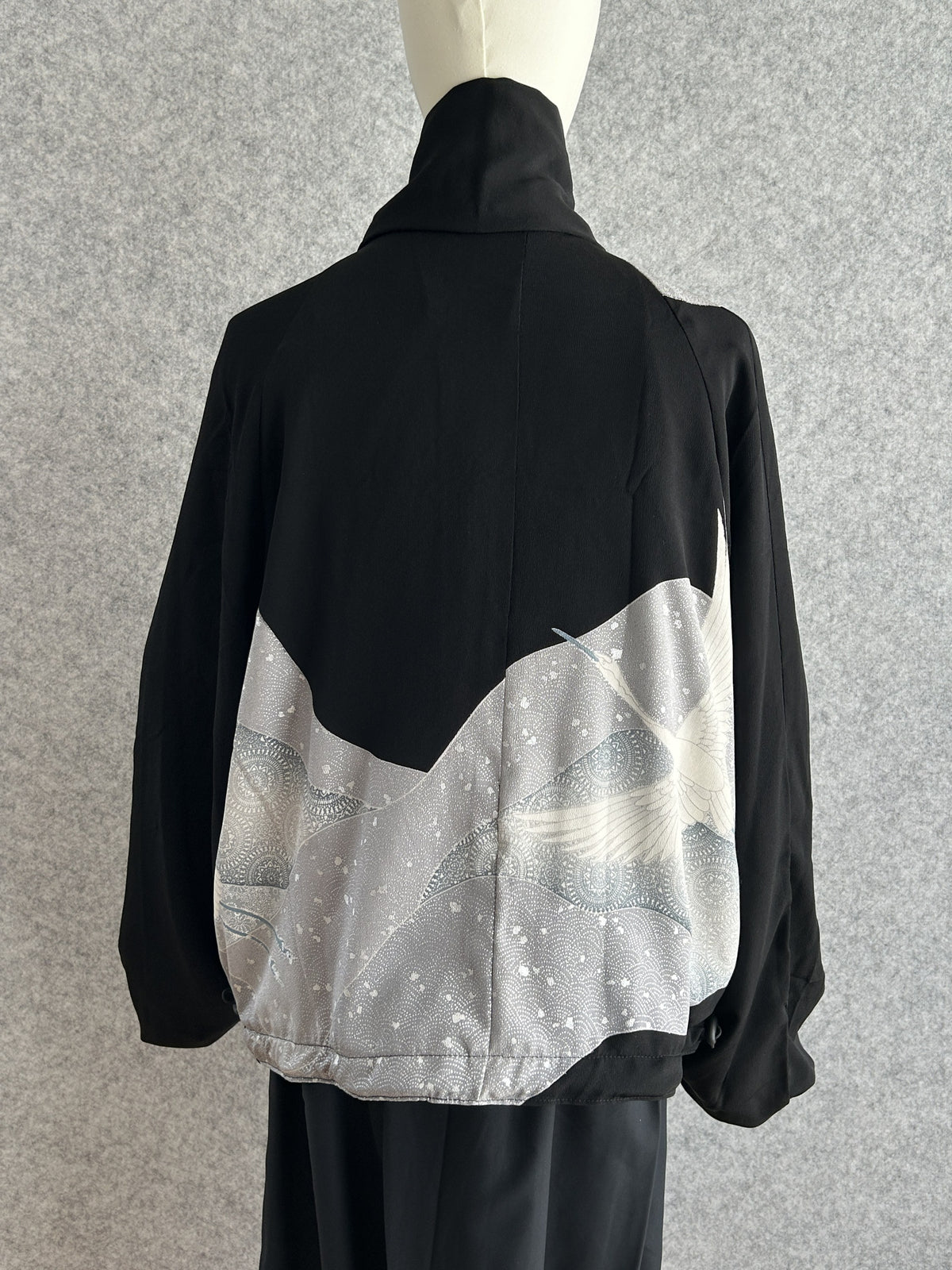 Black high collar kimono jacket with grey bird panel, back view