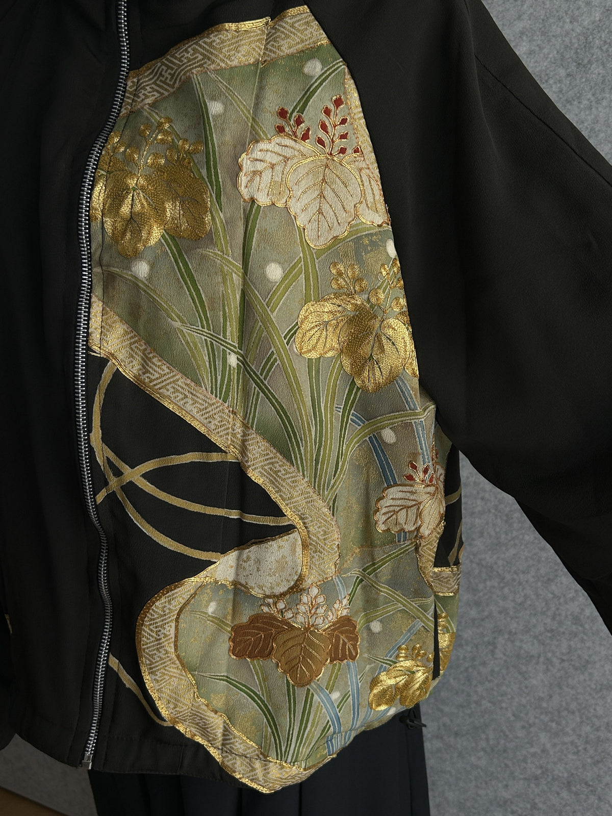 Black high collar kimono jacket, detail of gold leaves and grasses on front