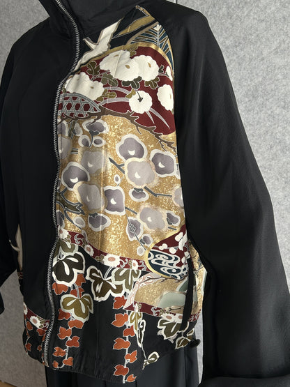 Black high collar kimono jacket, detail of front panel with blossoms and leaves