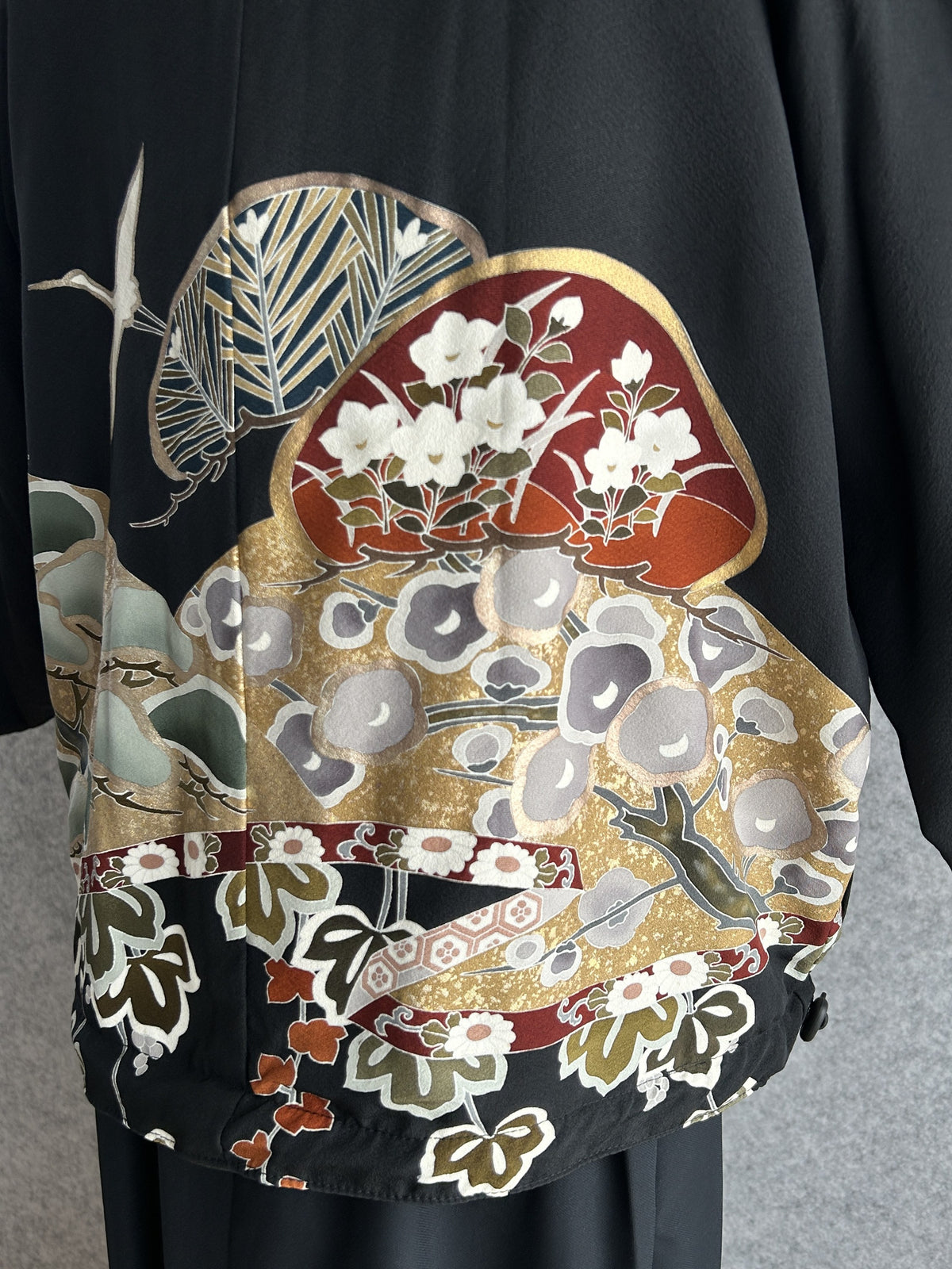 Black high collar kimono jacket, detail of fans and blossoms on back