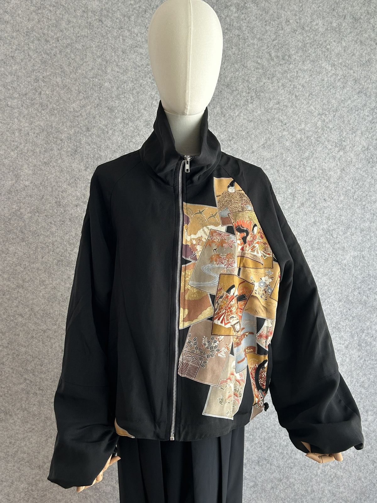 Black high collar kimono jacket with mustard and orange picture card design, front view