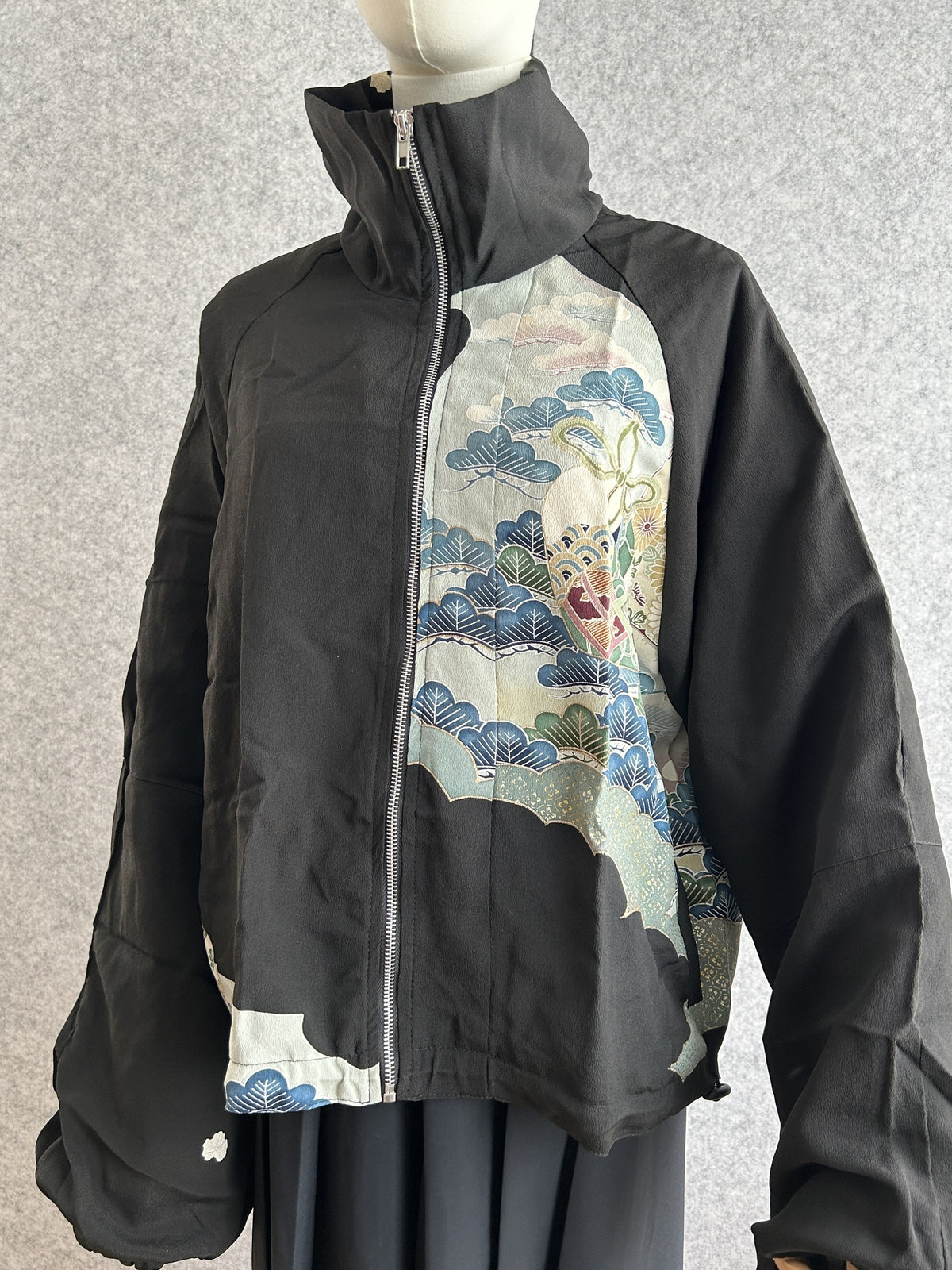 Black high collar kimono jacket with pale blue scenic panel, front view