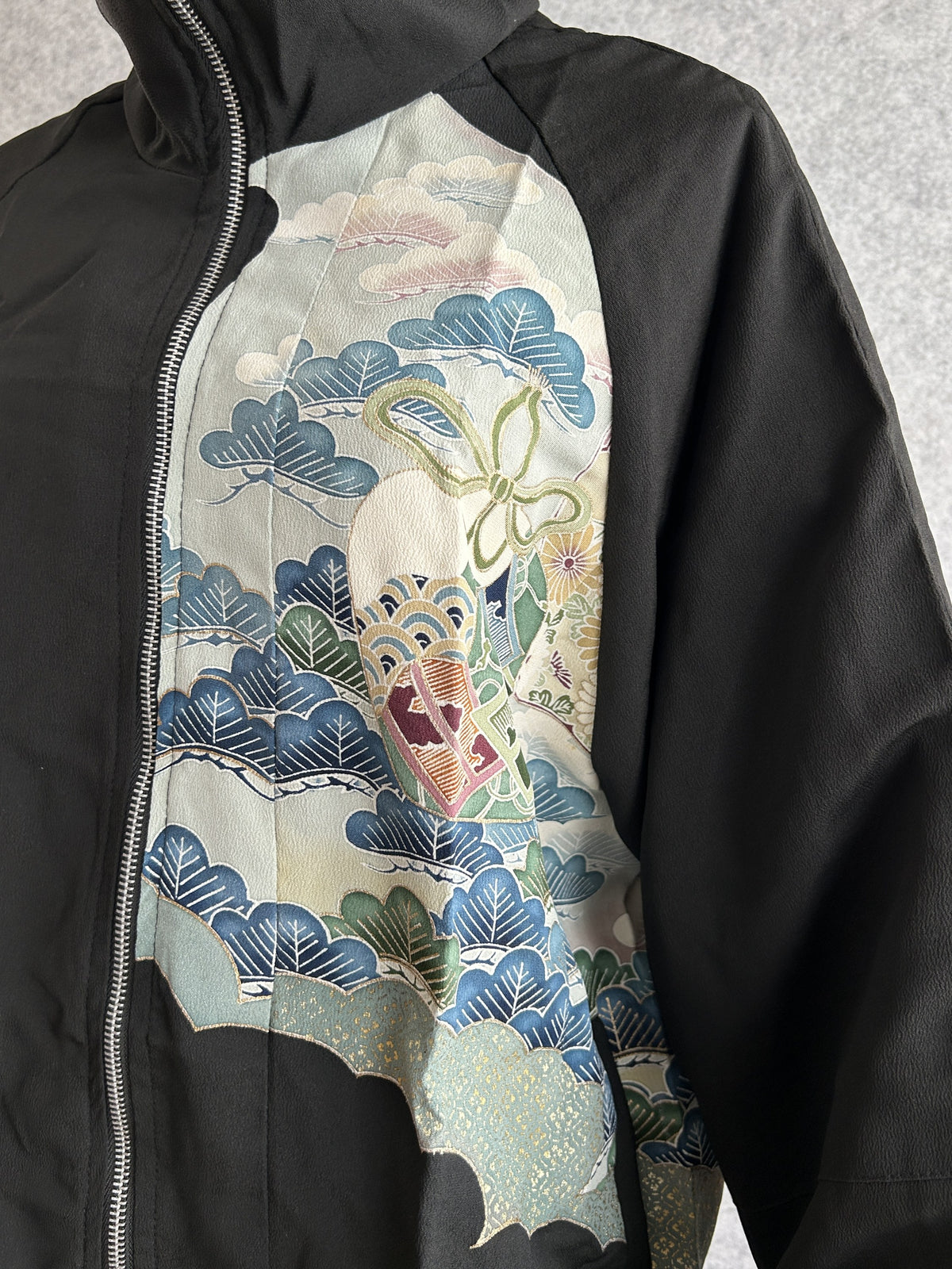 Black high collar kimono jacket, detail of blue trees and clouds on front