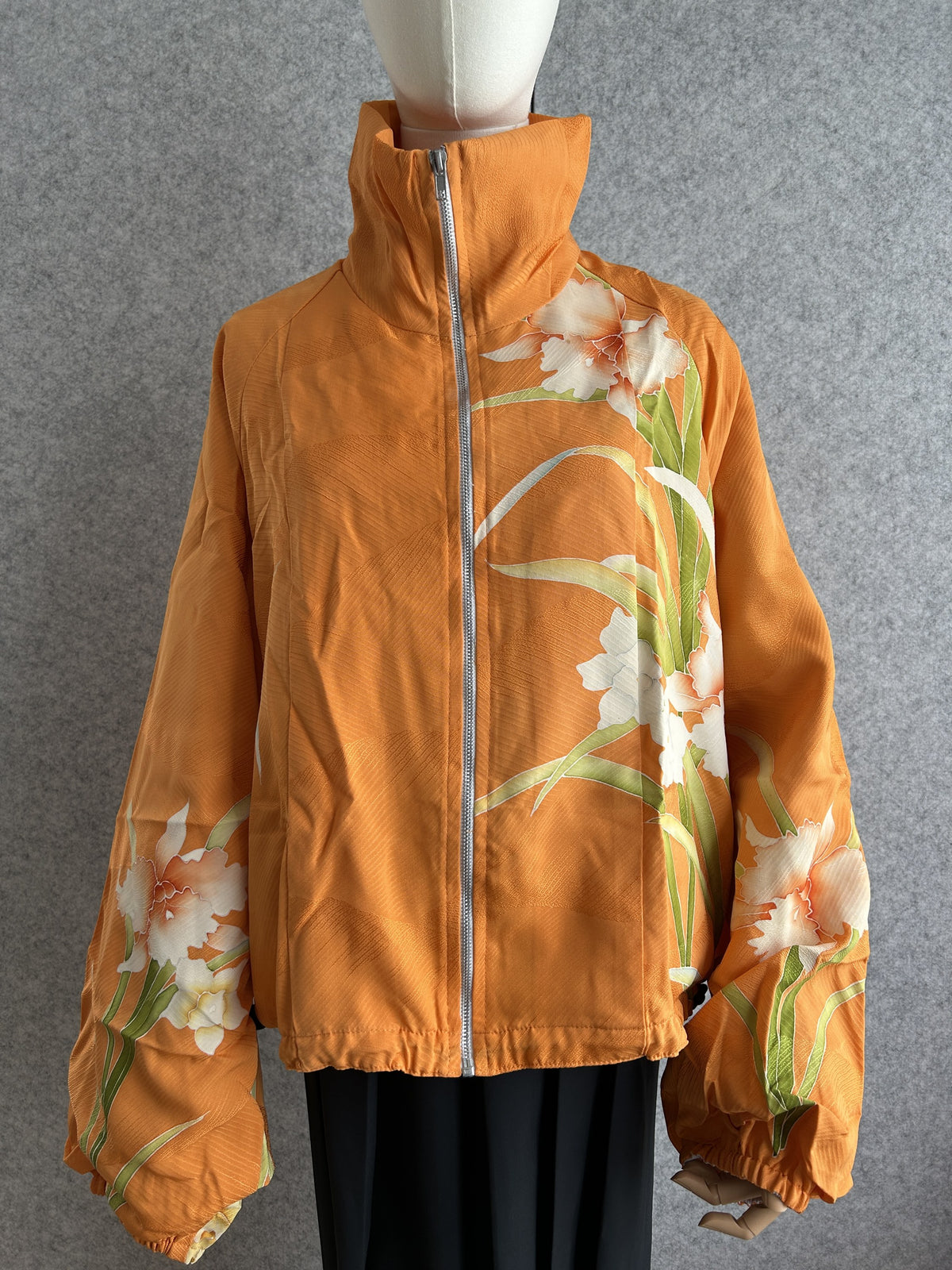 Orange high collar kimono jacket with large white flowers, front view